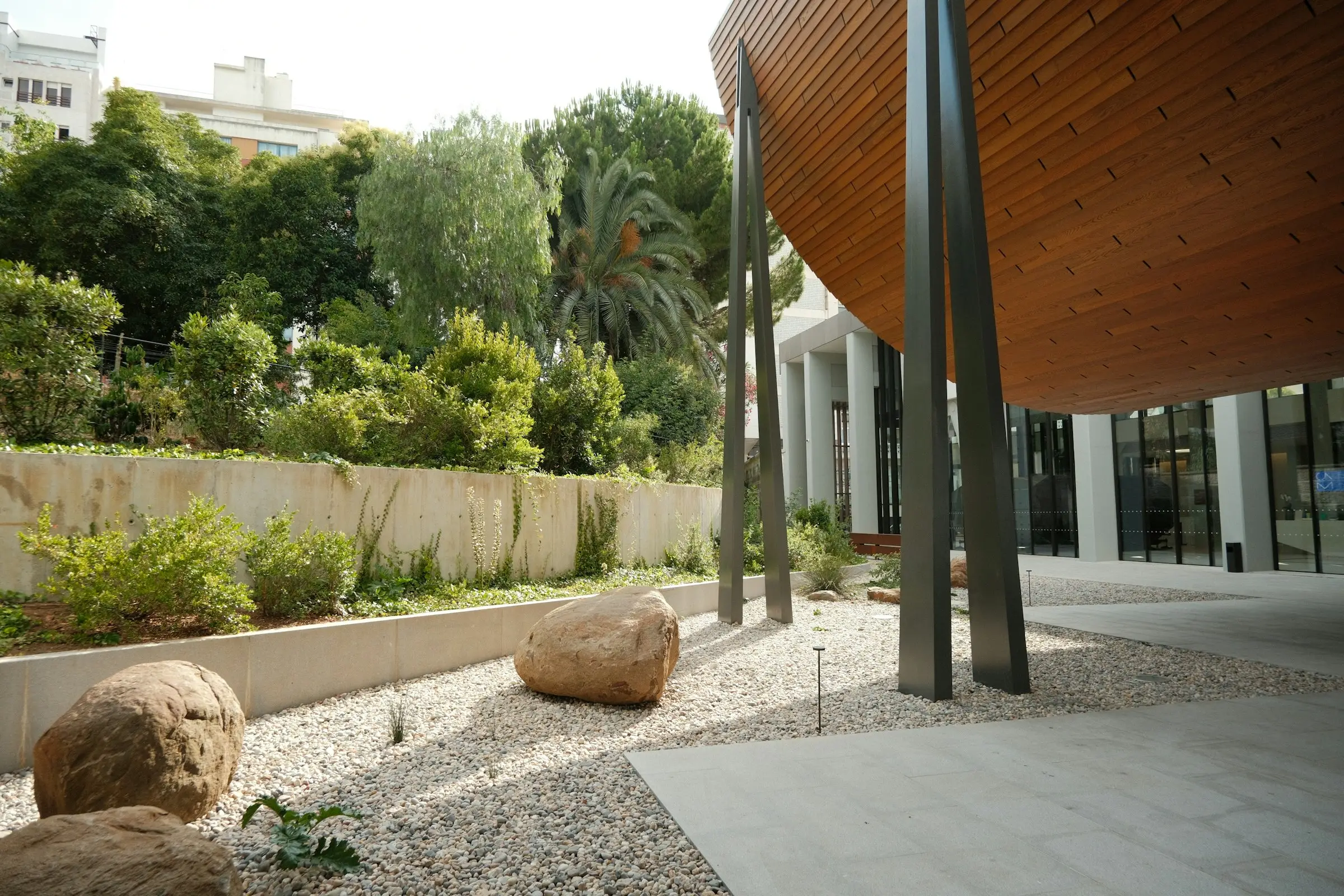 Stone terraces and lawn on a sloping block